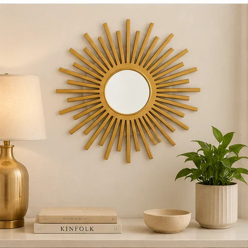 Gold matte sunburst wall mirror styled above a console table