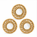 Set of three small golden round decorative wall mirrors on white background